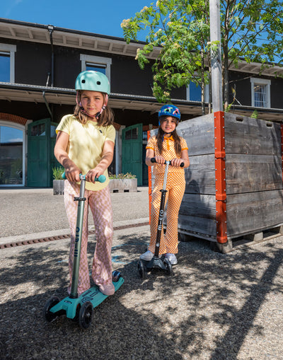 girls riding their eco kids scooters