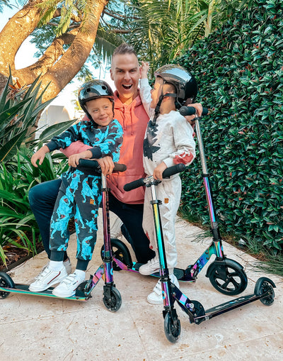 dad scooting with his kids on their awesome neochrome scooters