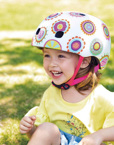 girl having fun while wearing a micro scooters doodle dot pattern helmet