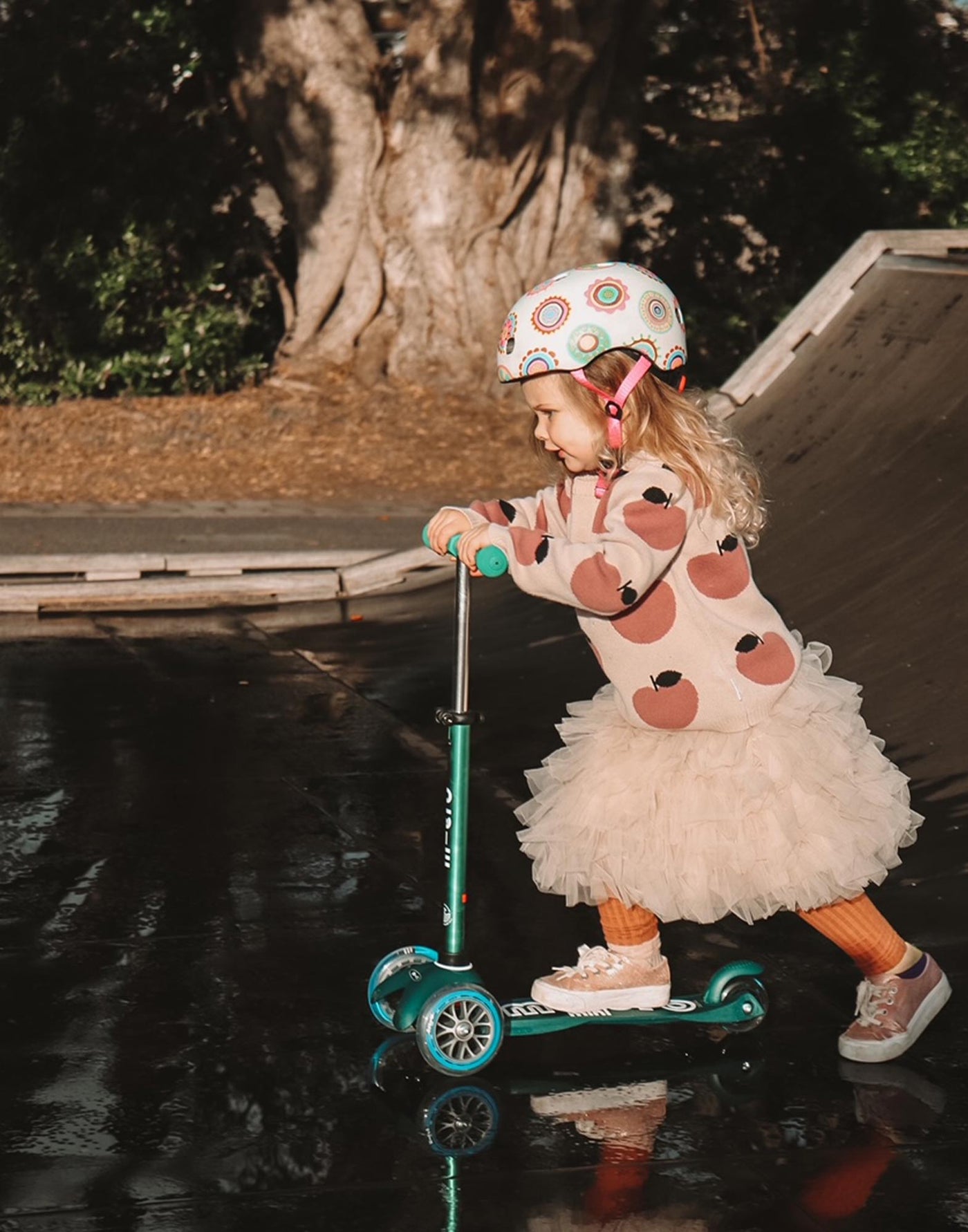 toddler riding her deep green mini deluxe eco scooter