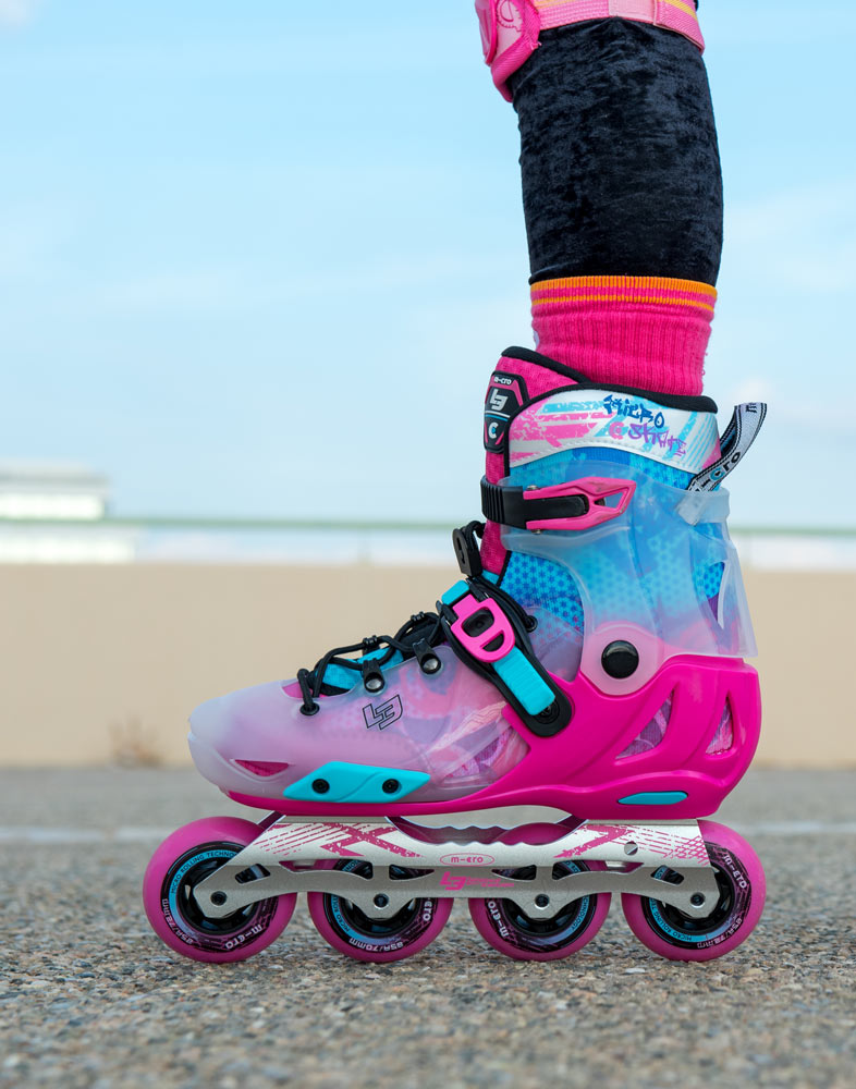 side on view of girl wearing pink limited edition infinite skates