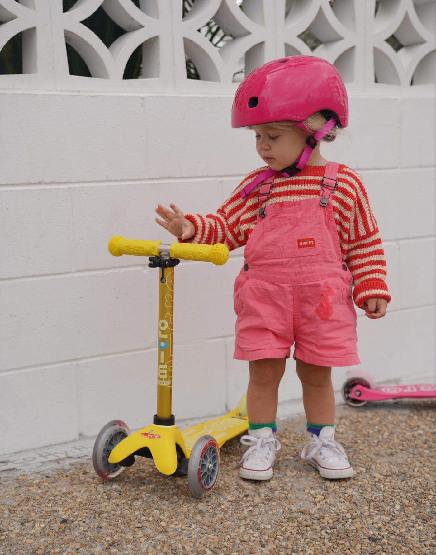 girl with mini deluxe yellow scooter