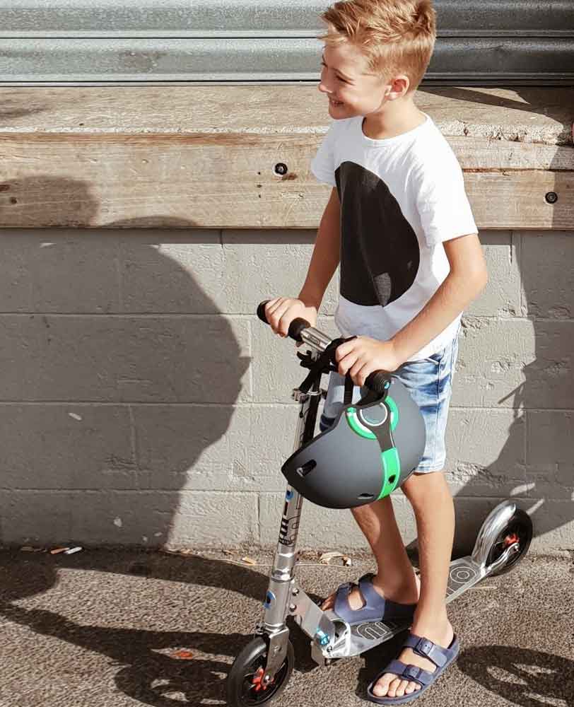 kid having fun on a pure silver speed 2 wheel scooter