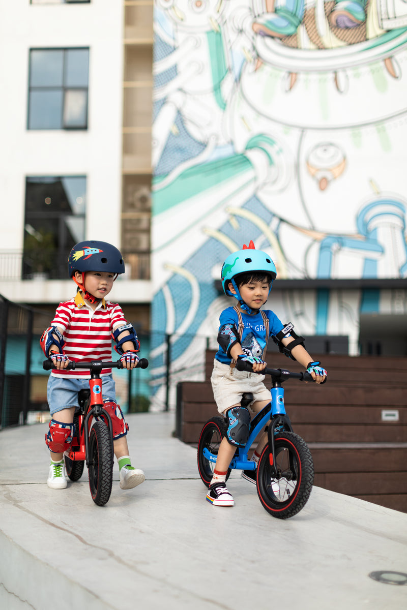 little boys on their red and blue balance bike deluxe