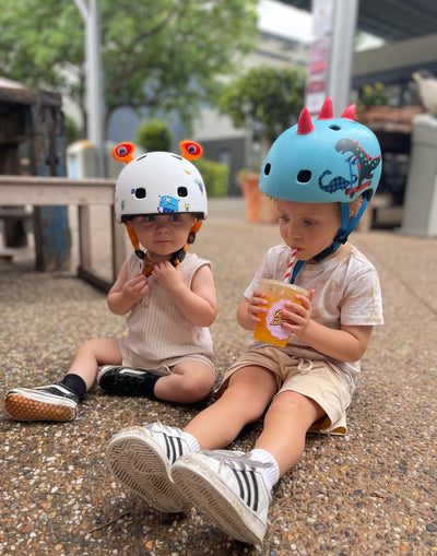 little boys wearing 3d monster and dinosaur helmets