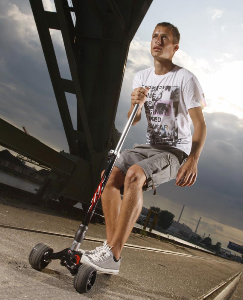 man riding a kickboard 3 wheel adult scooter