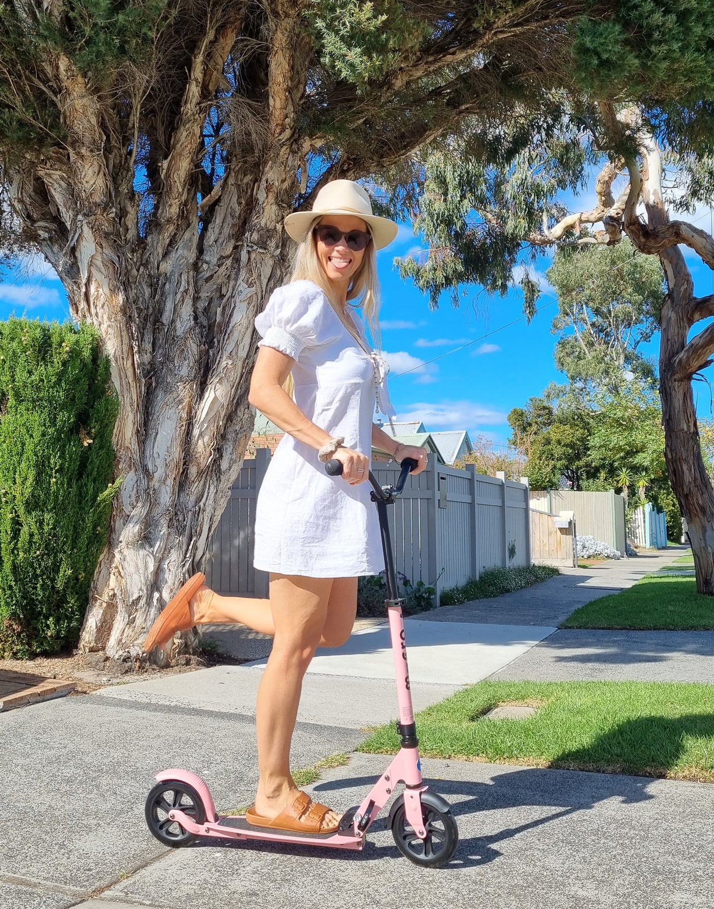 woman riding adult scooter in the sun