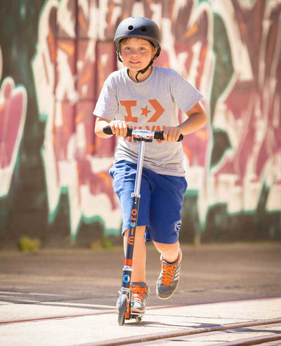 boy riding a black and orange speed 2 wheel scooter