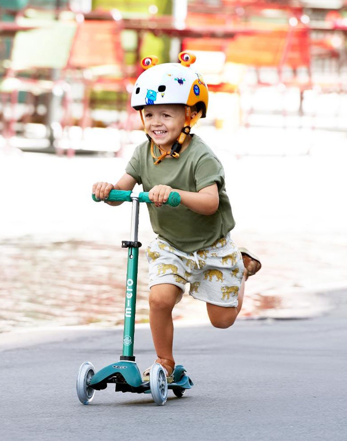 preschooler on his mini deluxe deep green eco scooter