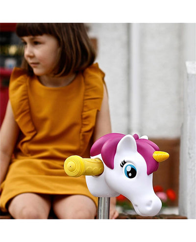 toddler with her pink and white unicorn scooter head accessory