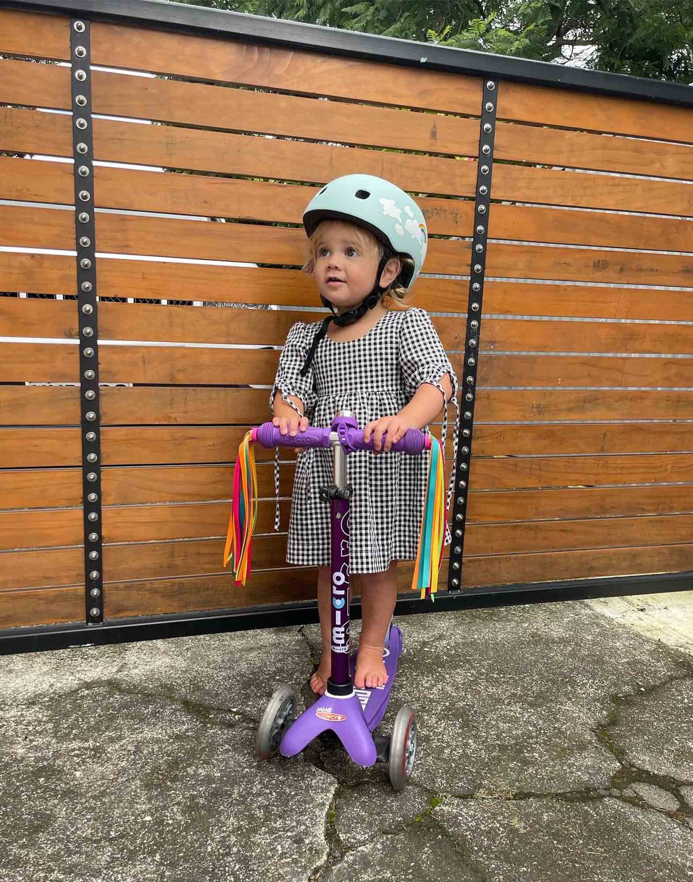 toddler on her purple mini deluxe with ribbons